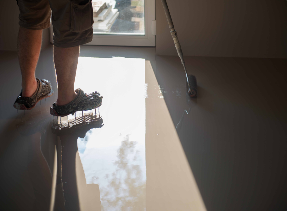 worker applying black epoxy resin in a big open em 2024 02 02 14 37 12 utc 1